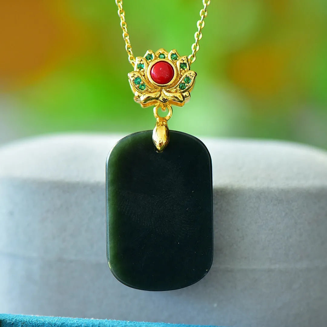 Gray Hetian jade flat pendant with copper inlay on an ink blue cord necklace.