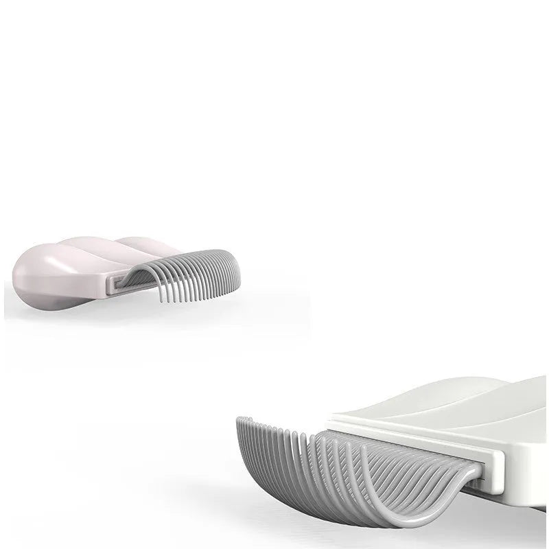 Paw Soft deshedding grooming brush for cats and dogs on a white surface.