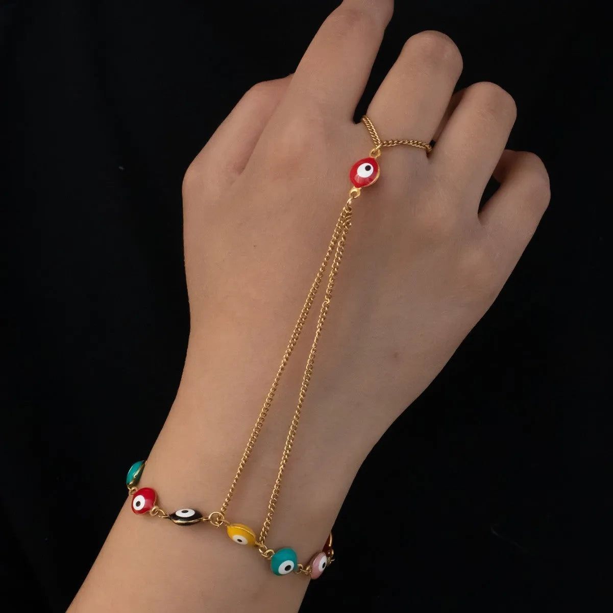 Women's titanium steel round eyes lucky mitten-type bracelet in colourful electroplated finish on a neutral background