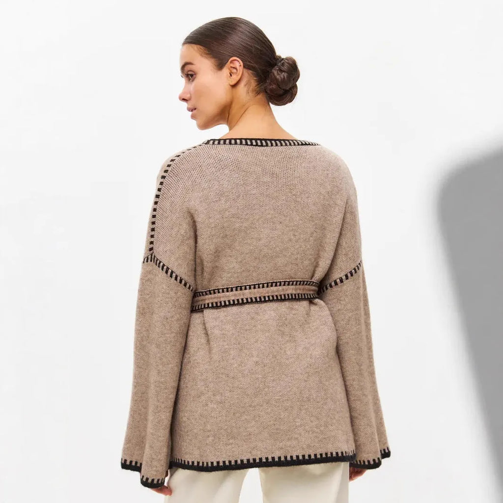 Loose fit lace-up knitted cardigan in black, shown as a mid-length sweater coat.