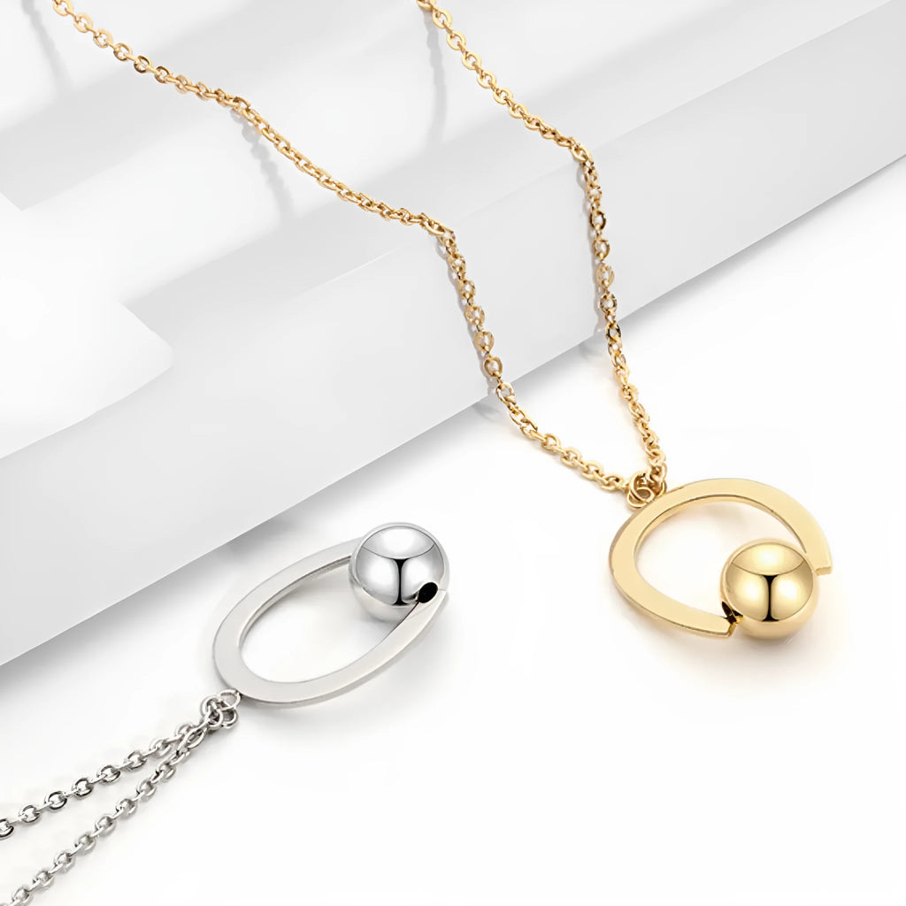 Stainless steel geometric pendant necklace on a cross chain, shown in a gold colour finish.