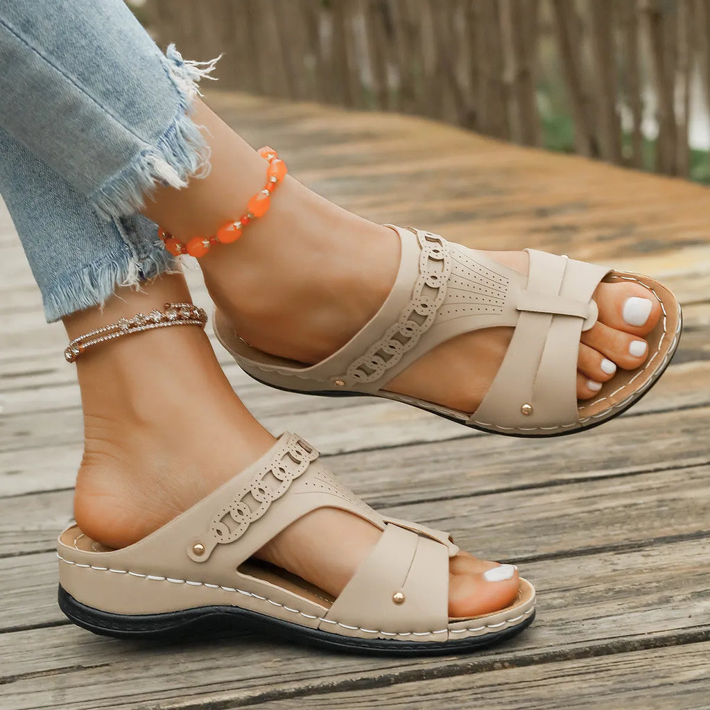 Pair of casual Roman style slippers with a fish mouth toe holder and slope heel, shown in a choice of colours.