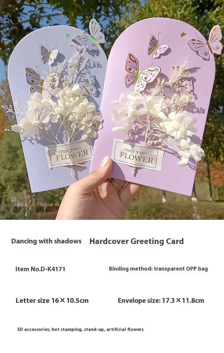 Handmade 3D butterfly birthday greeting card with artificial flowers, shown with its envelope.