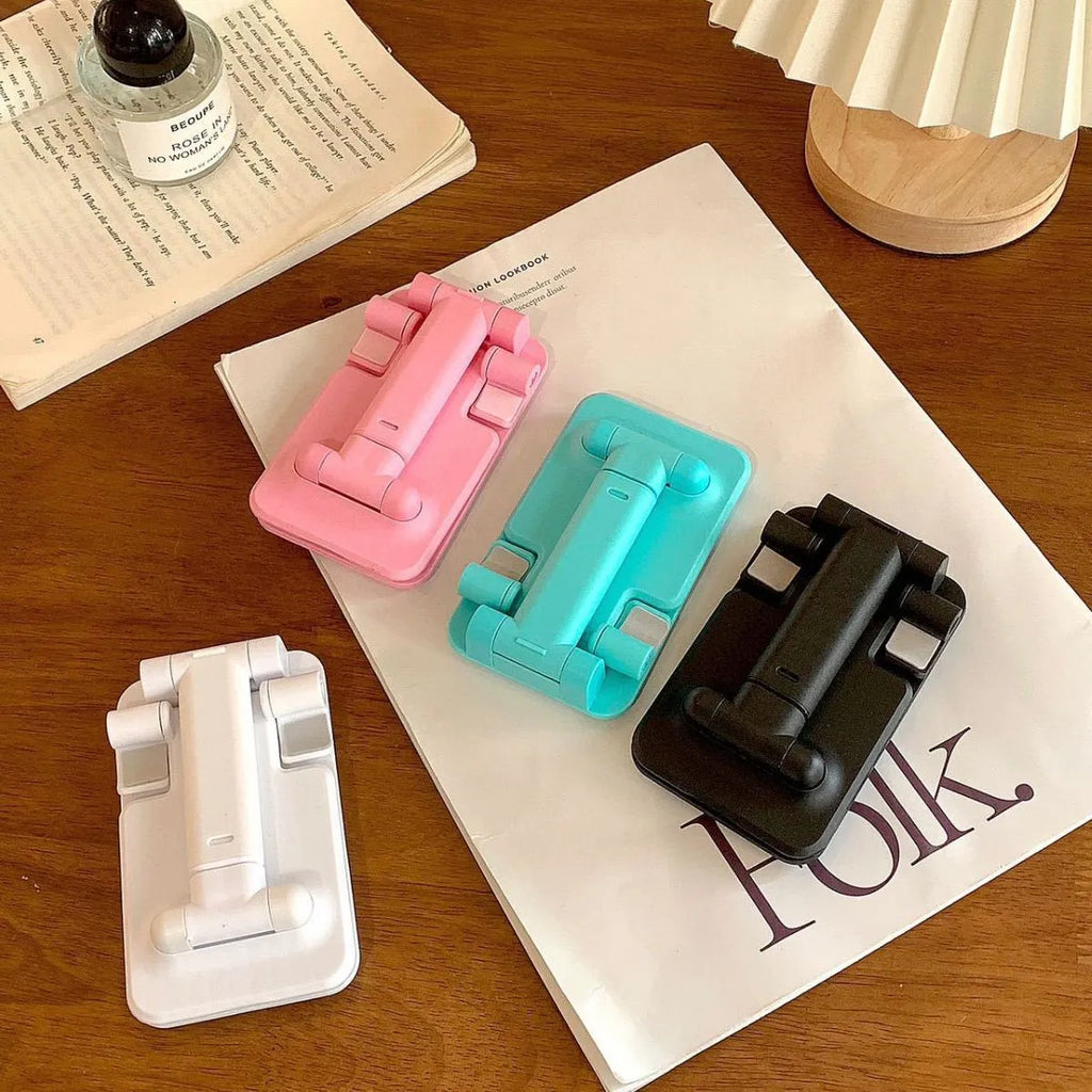 Folding plastic mobile phone stand in white, showing universal groove for hands-free viewing