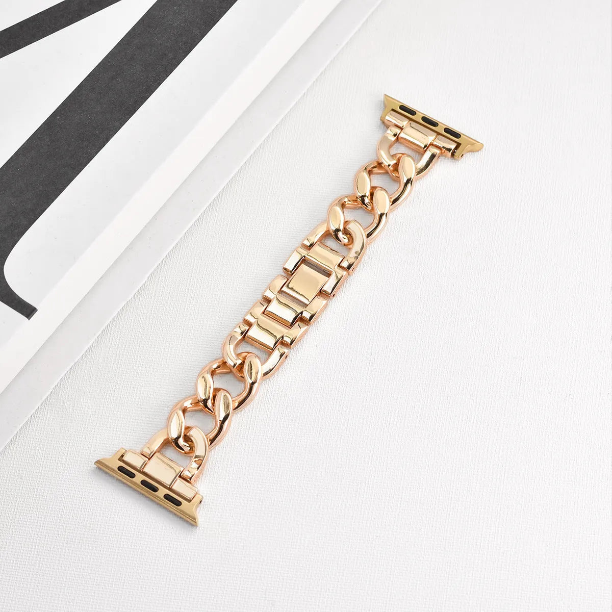 Metal denim chain watch strap for Apple Watch in multiple colours on a grey background.