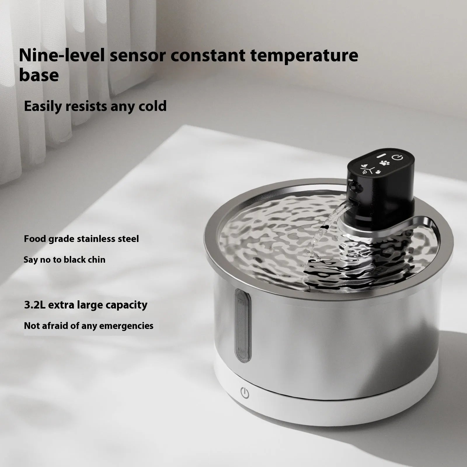 Stainless steel pet water fountain with a white constant temperature heating base on a wooden floor.