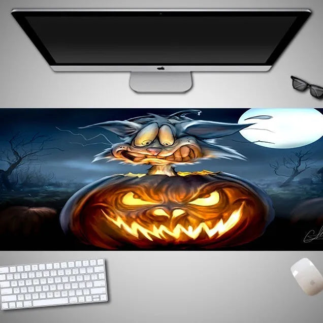 Large Halloween-themed rubber cloth mouse pad on a desk, showing non-slip backing and graphic design.