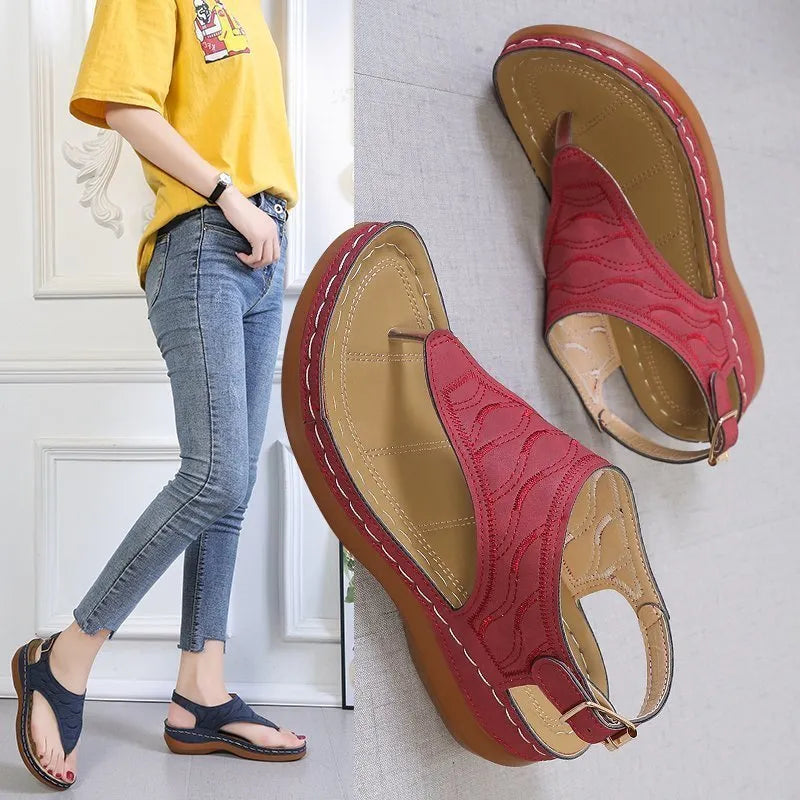 Women's wedge heel flip flop sandals with an adjustable back strap in solid black.