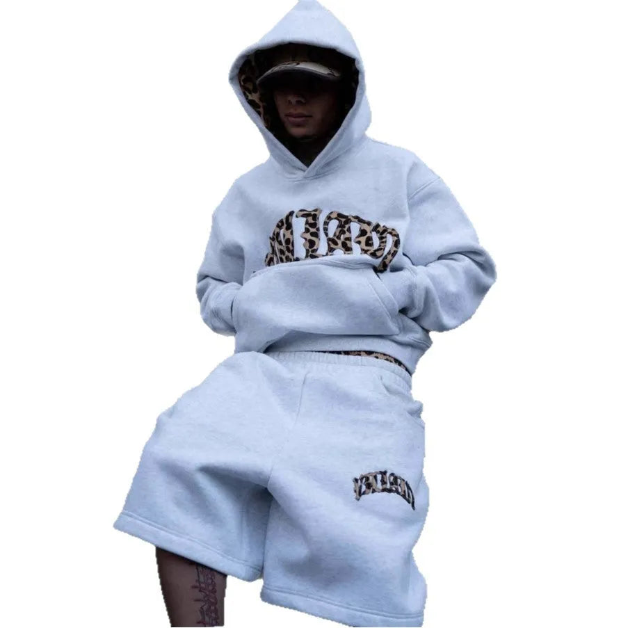 Men's loose grey patchwork double waist hip hop trousers with a zip fly, laid flat.