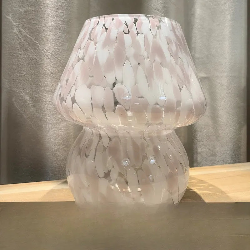 Flame mushroom pink and white glass mushroom table lamp with USB power and three-color light on a bedside table