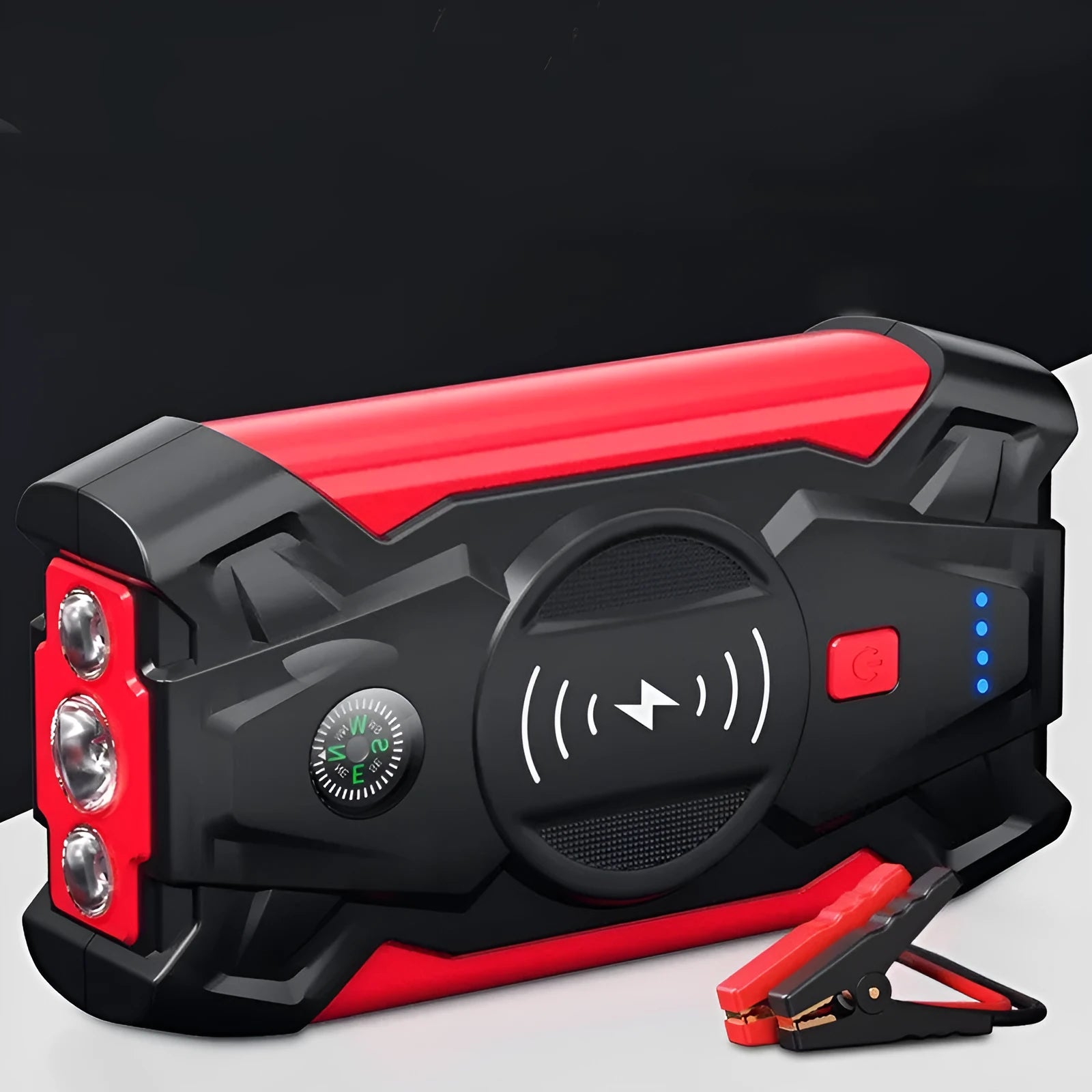Red car emergency jump starter power pack with digital display and strong jumper clamps.