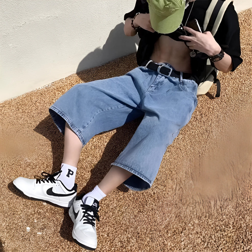 Blue washed denim men's shorts with a high waist and cropped, straight-leg pirate style.