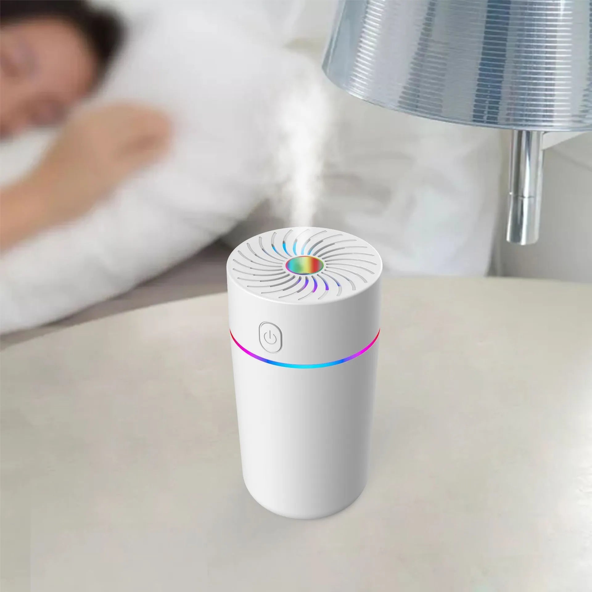 A small white or black USB car humidifier with aromatherapy function on a car dashboard.