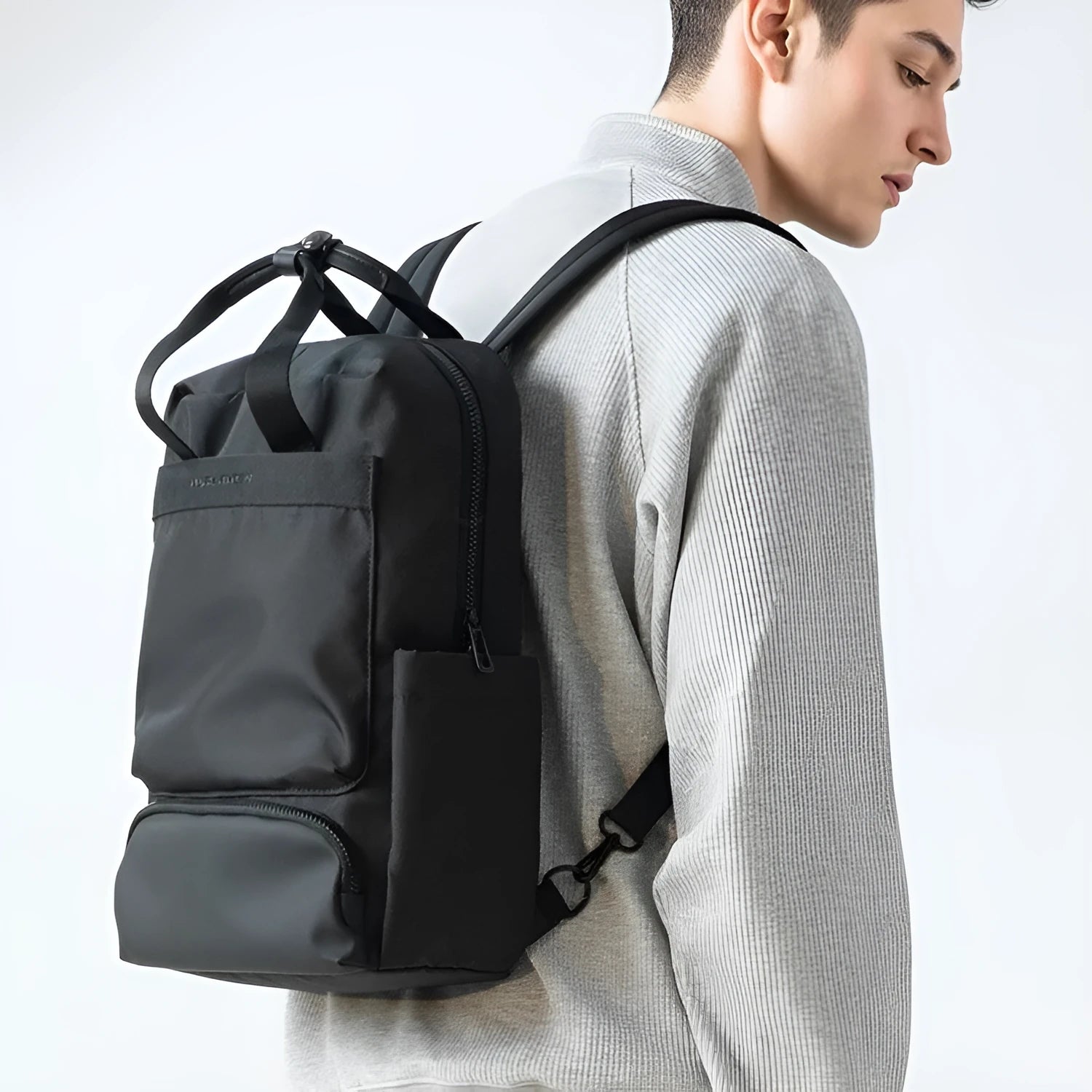 Black Oxford cloth computer backpack showing front view and storage compartments.
