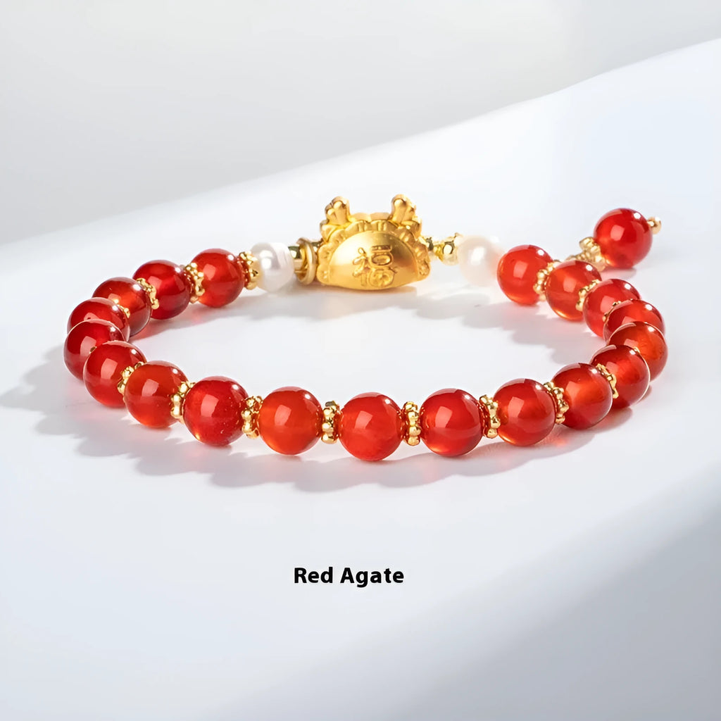 Close-up of an 8mm diamond-shaped bead bracelet in red agate, showing its unisex design.