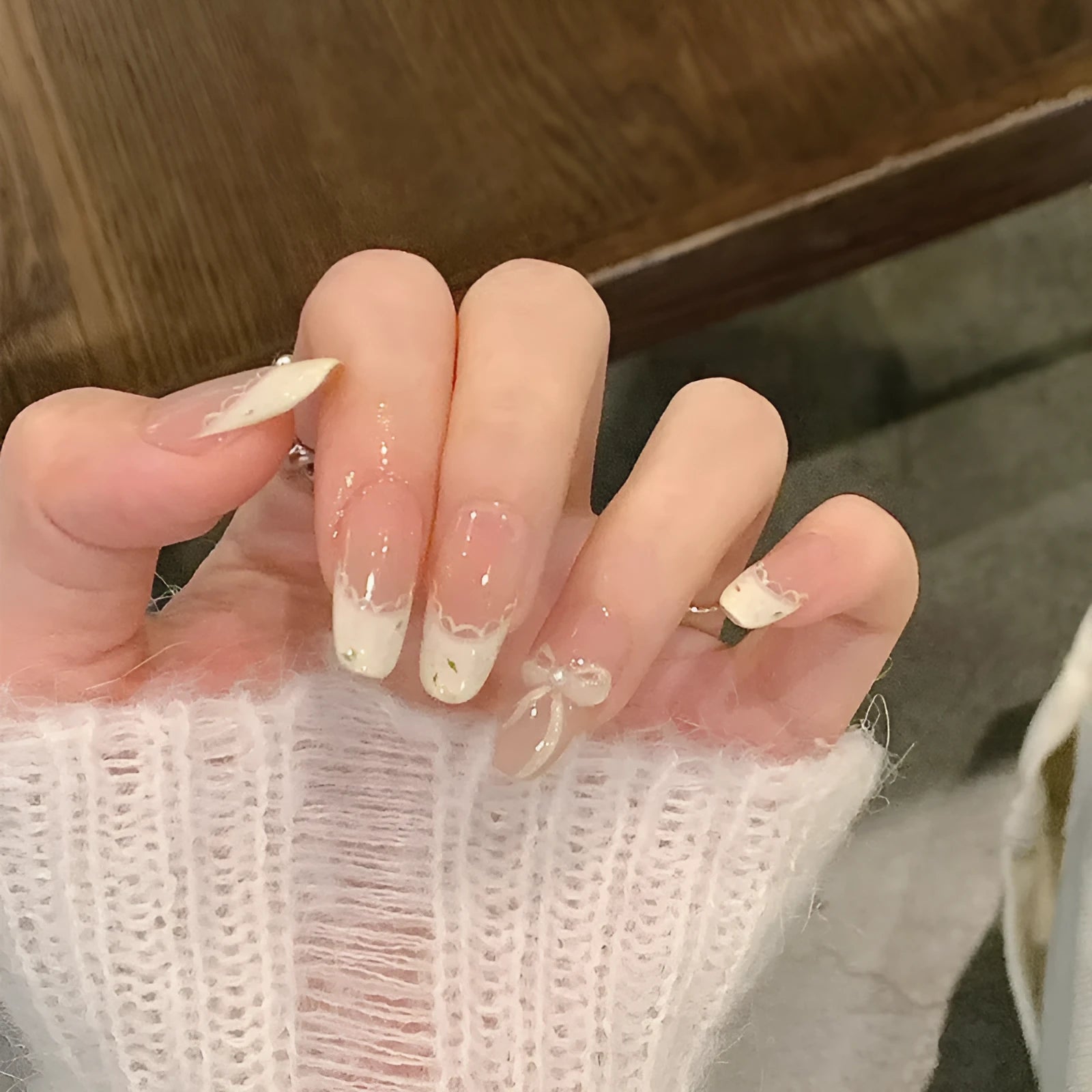 Sweet Girl Wearing Fake Nails set showing medium length coffin-shaped press-on nails with random colour designs.