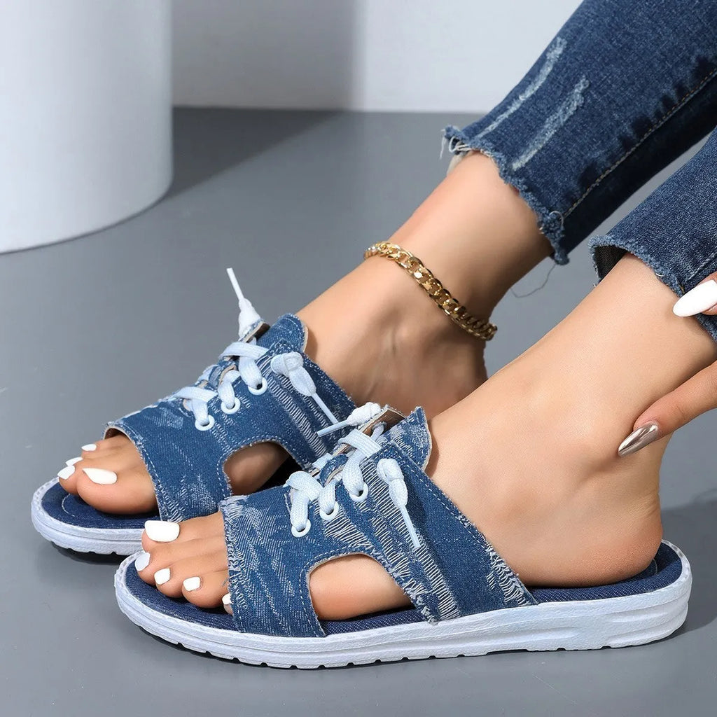 Blue women's Roman style flat canvas slippers with a rubber sole.
