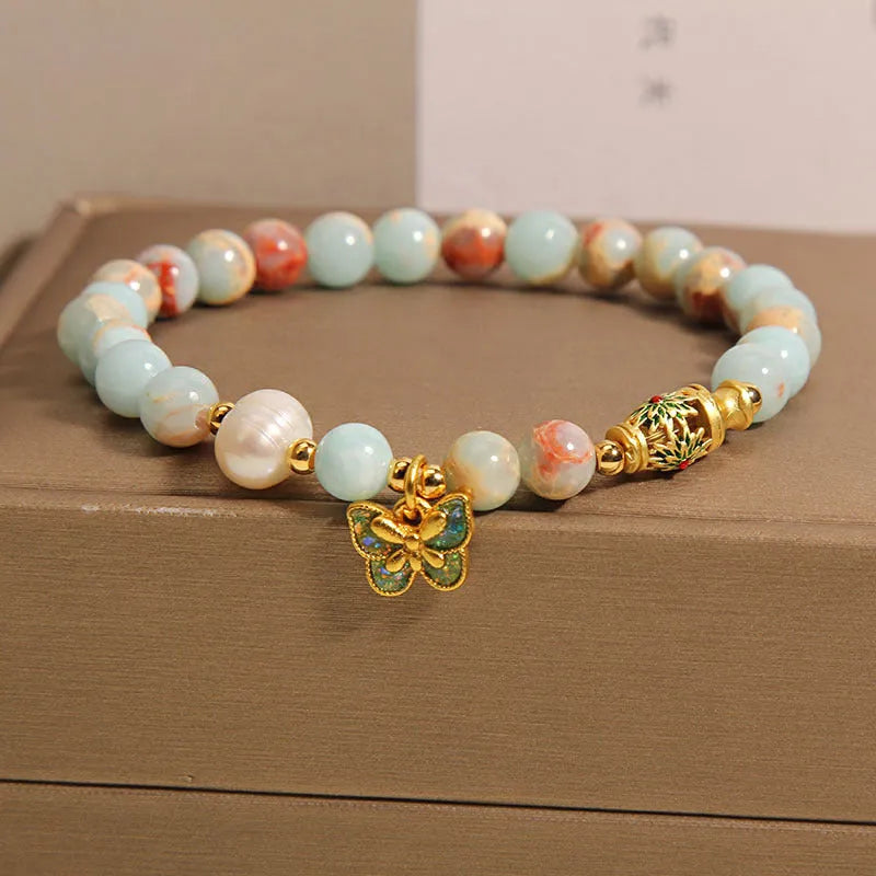 Blue freshwater pearl bracelet with Shoushan stone accents and detailed butterfly pendant
