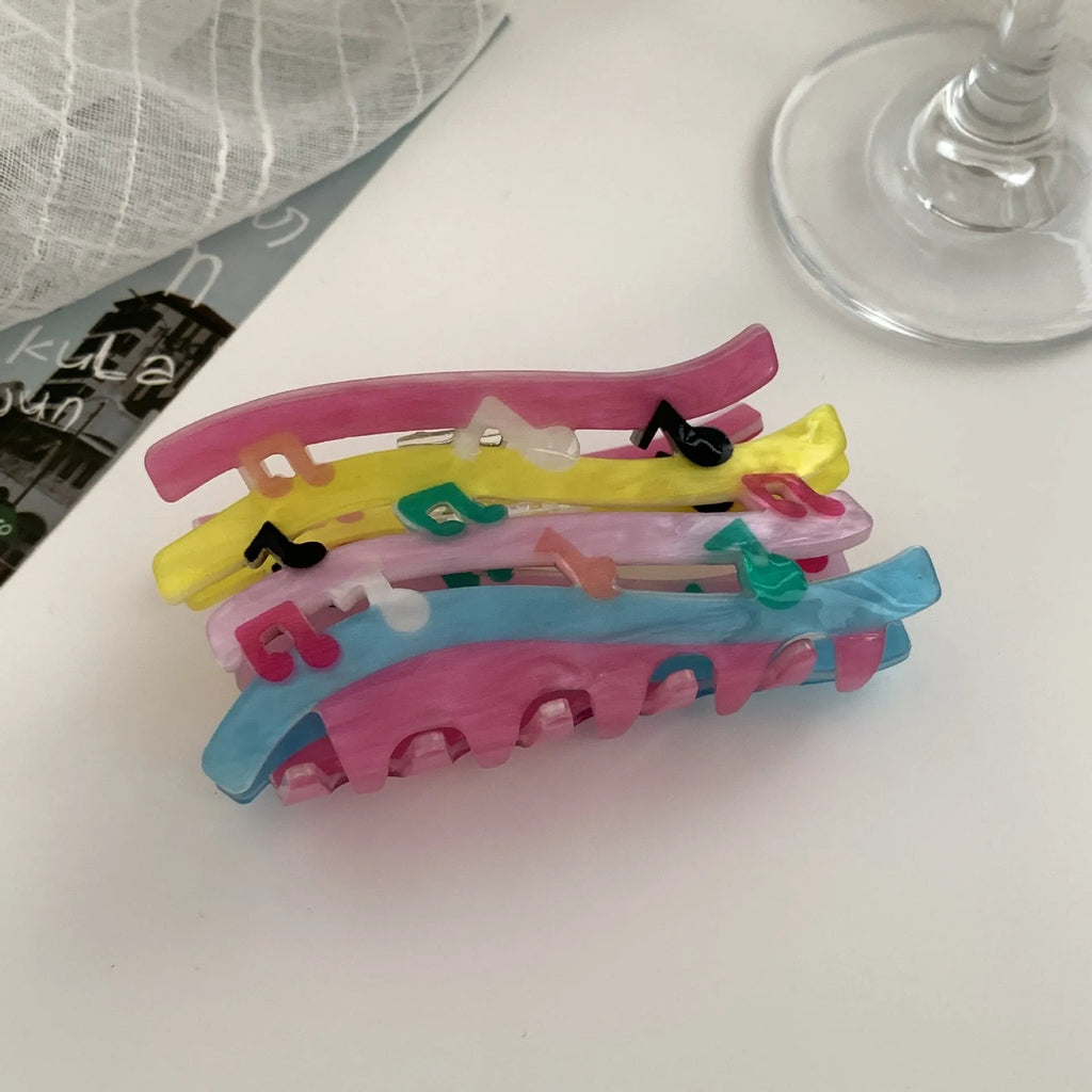 Acrylic candy color wave mixed colour notes hair grip with irregular shape on a background