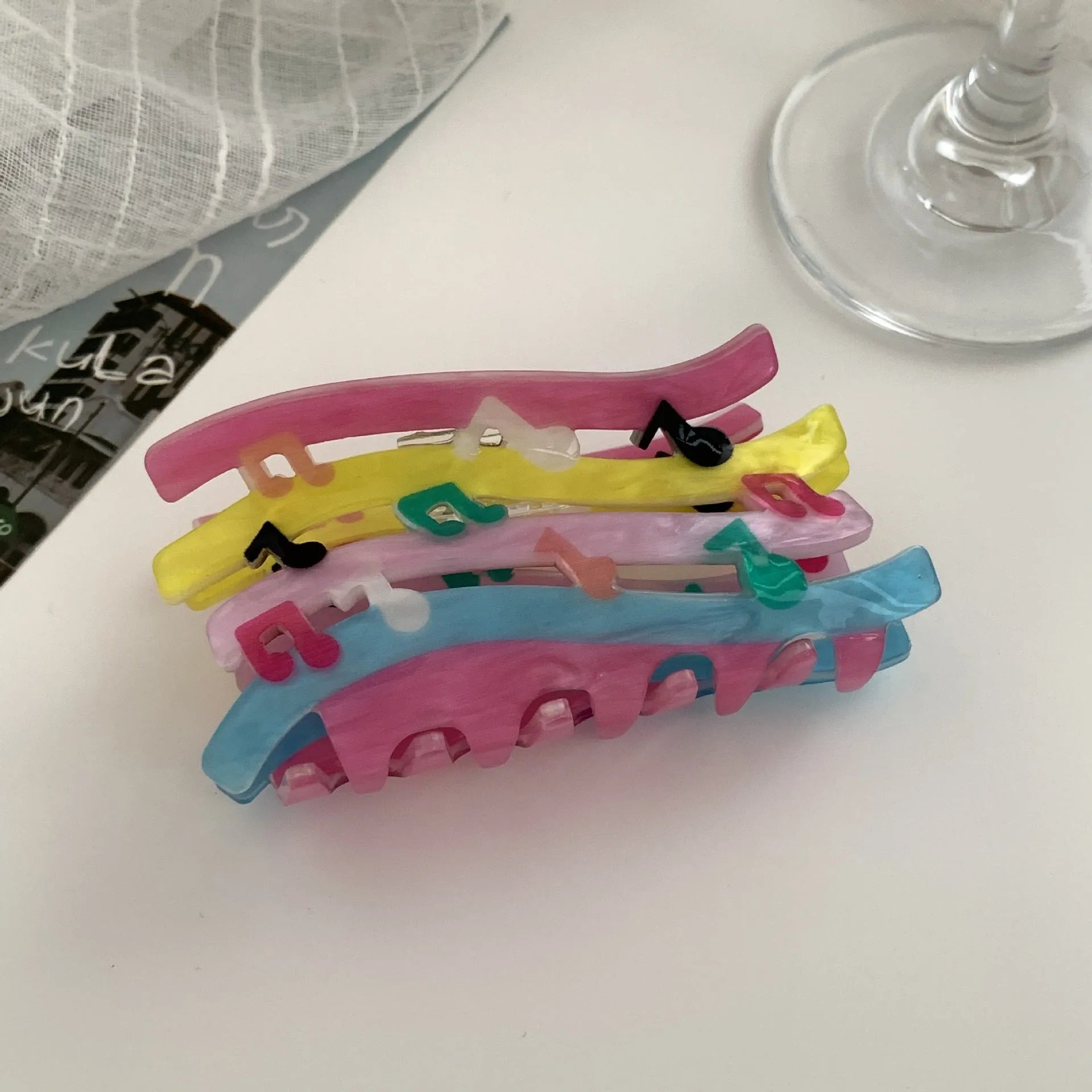 Acrylic candy color wave mixed colour notes hair grip with irregular shape on a background