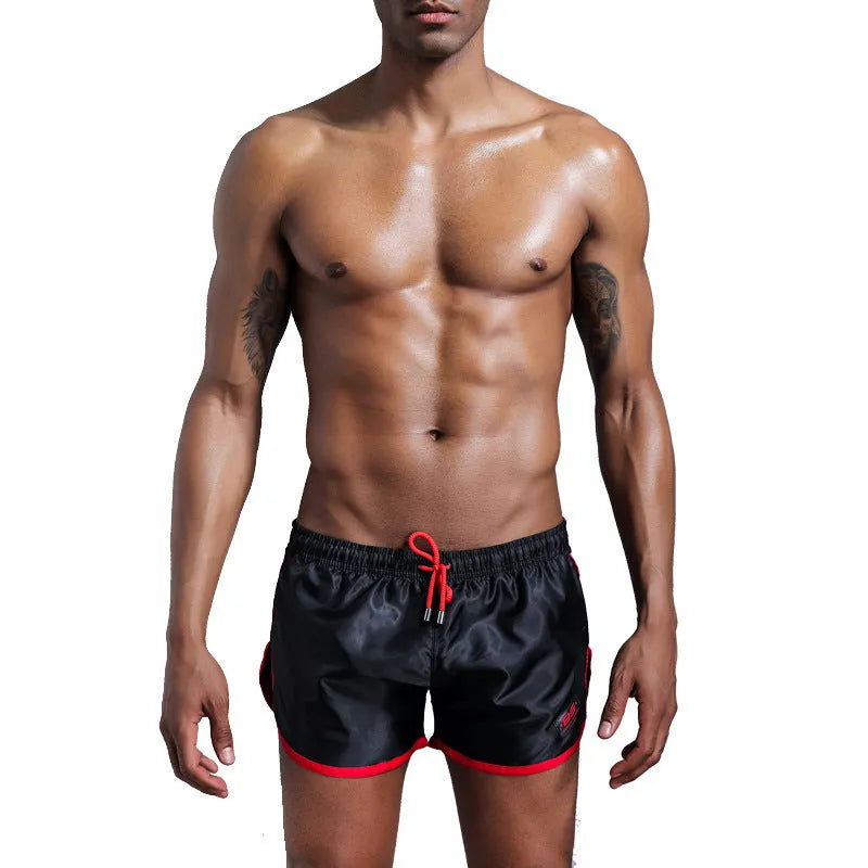 Men's solid colour polyester sports shorts in blue showing smooth beach pants design for fitness and swimming