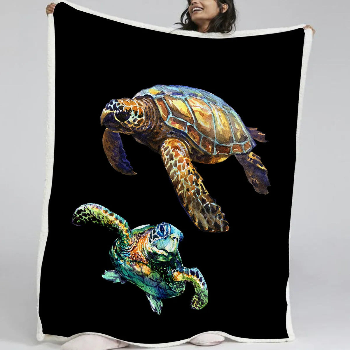 Black turtle pattern Sherpa fleece blanket on sofa, soft warm throw for home or camping
