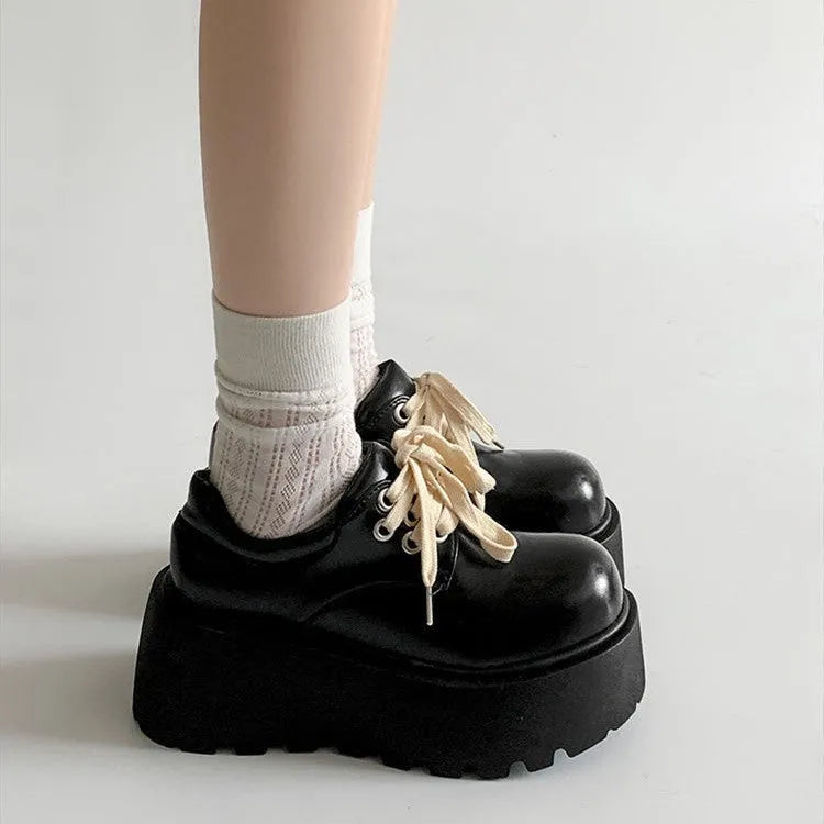 Matte black women's lace-up high-heeled shoes with a thick rubber sole and English muffin heel.