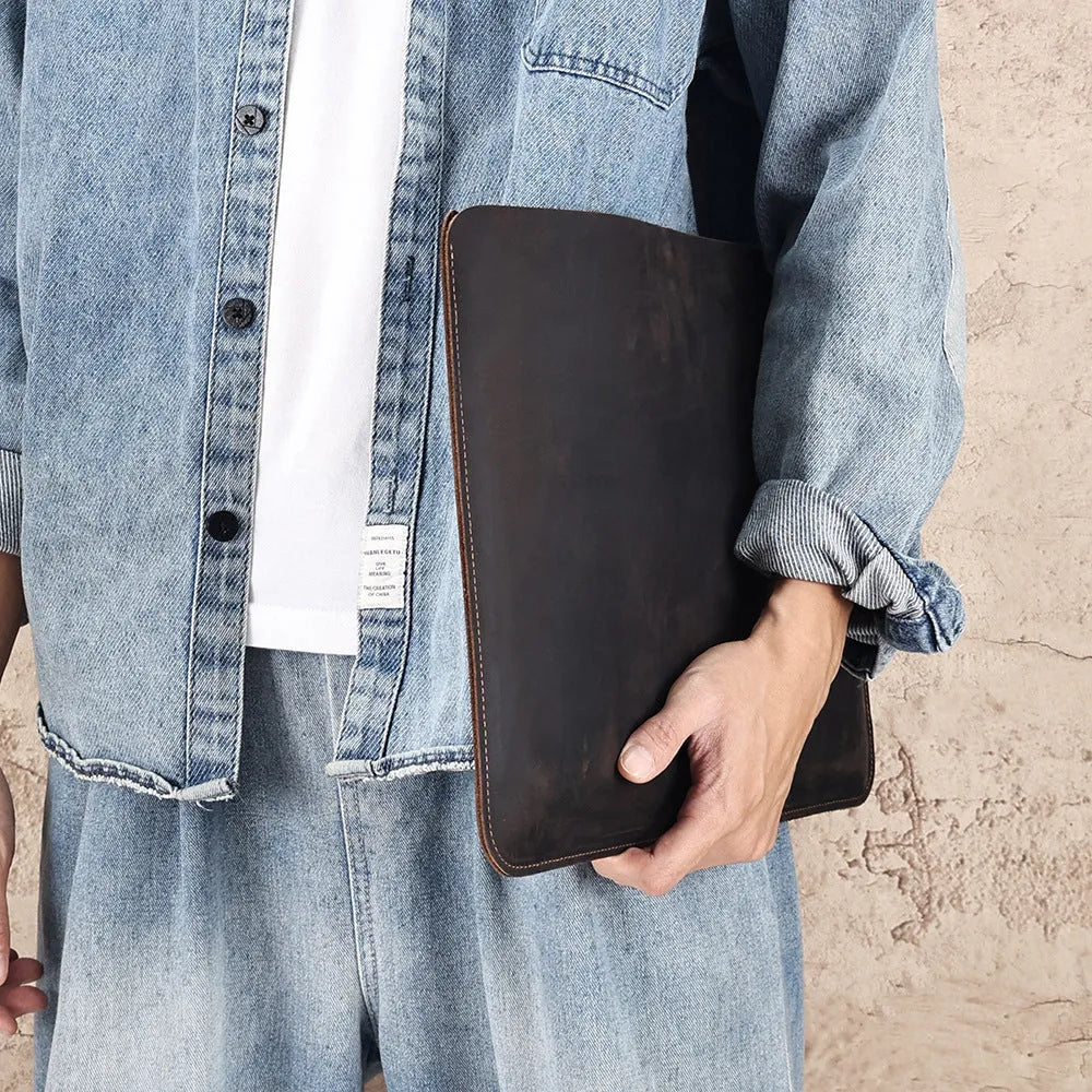 Brown genuine leather horizontal computer bag liner organiser with a laptop inside