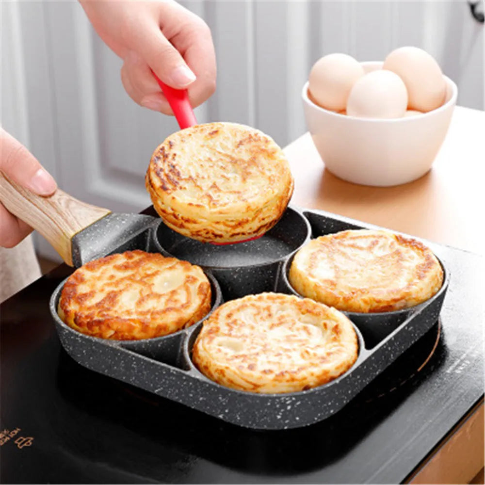 Four-hole non-stick aluminium frying pan with wood handle, silicone spatula, and oil brush.