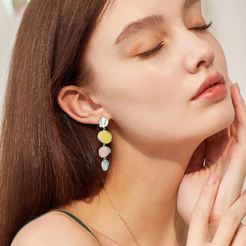 A pair of simple disc-shaped earrings with a blended Morandi colour finish on a sterling silver post.