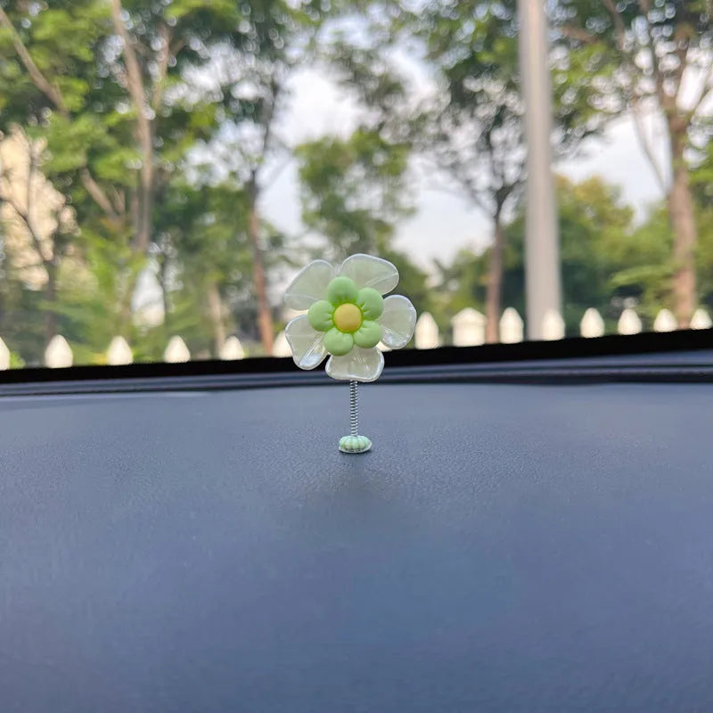 Small blue plastic swing ornament for car rear-view mirror, approx. 5cm tall.