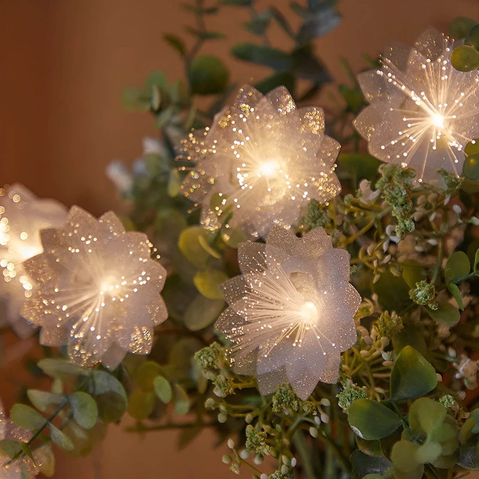 LED optical fibre flower light string with 20 warm white beads and battery box on a table decoration
