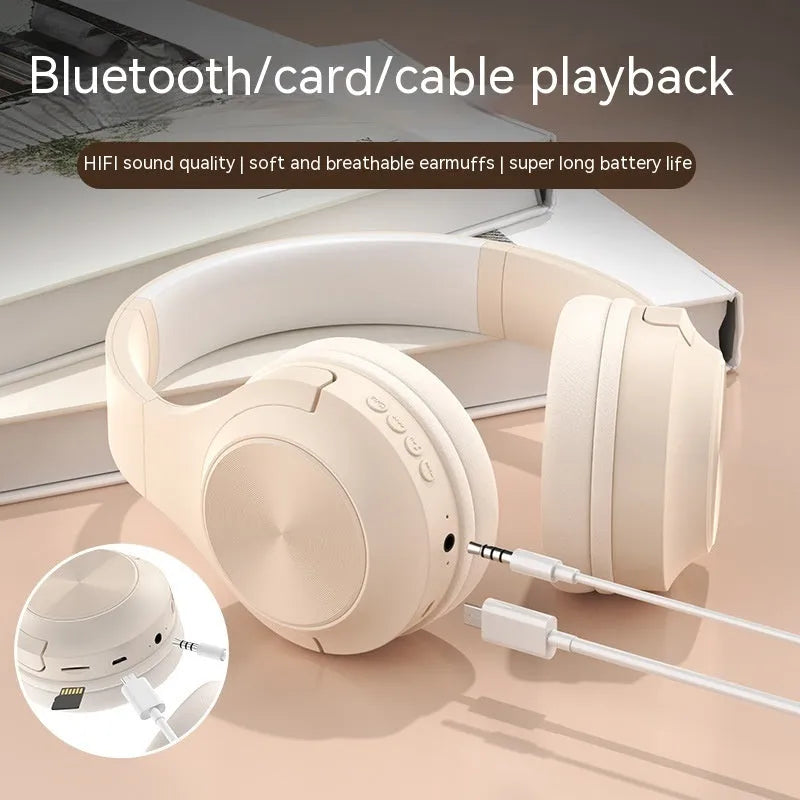 Over-ear wireless Bluetooth headset in Ivory White with a matching charging case on a table.