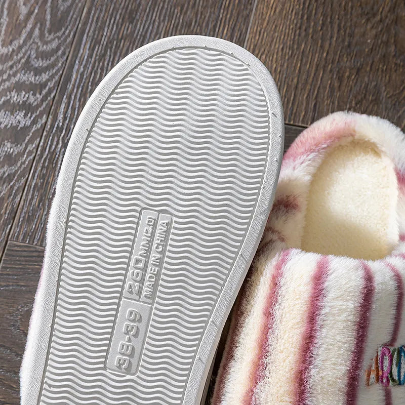 A pair of soft cotton adult slippers with a plastic sole, shown in one of five colour options.