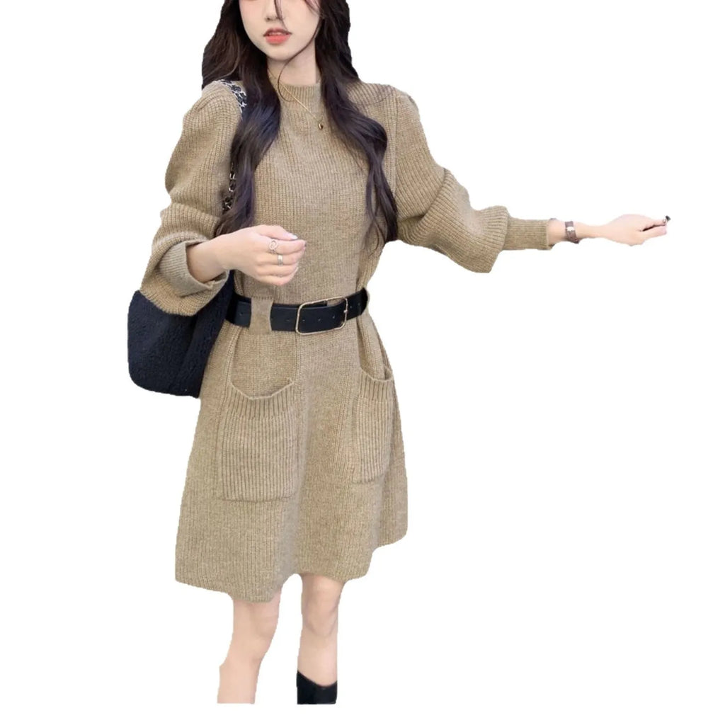 Women's beige loose knitted long sleeve dress with high waist and a black belt.