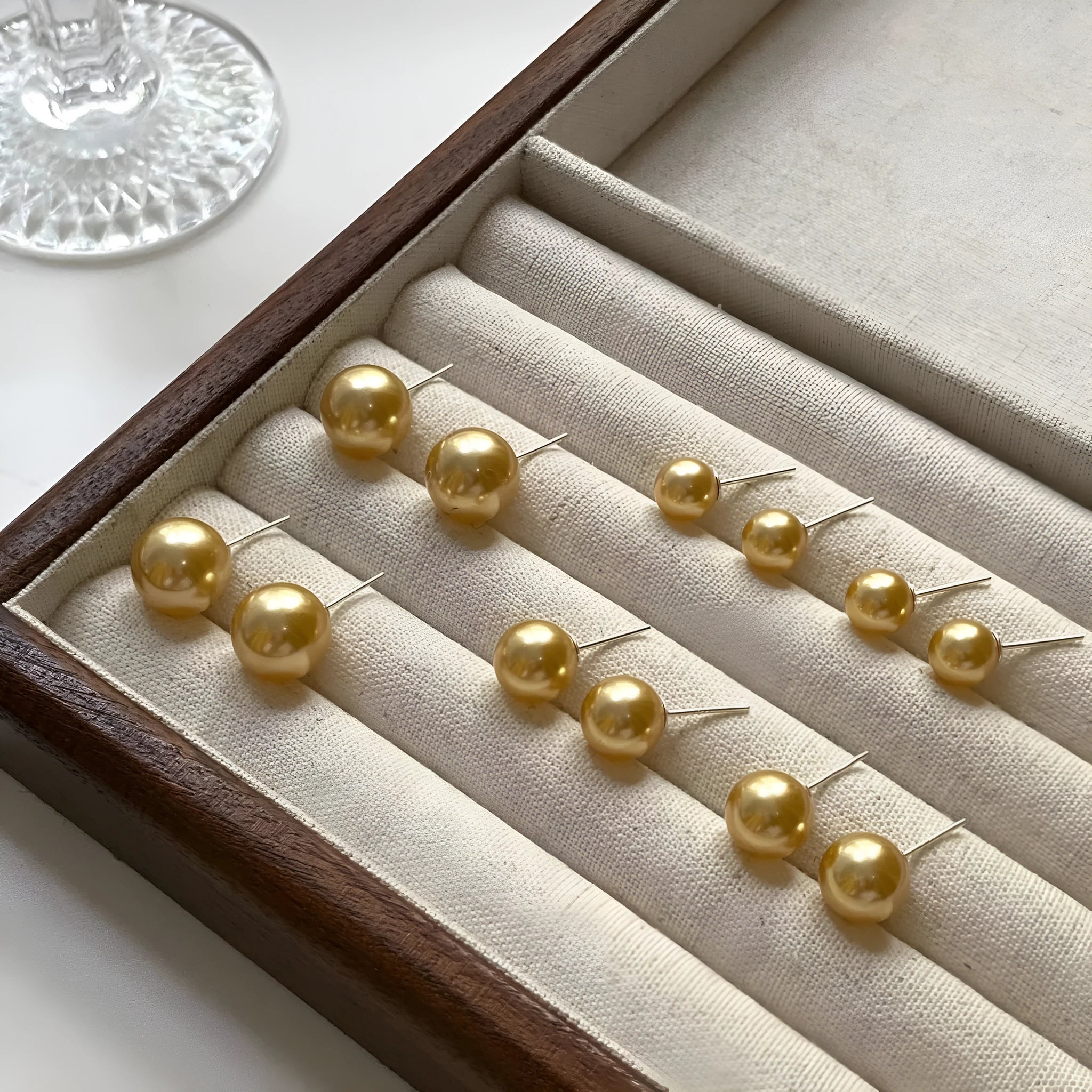 Close-up of a women's large pearl stud earring with an eight-point geometric silver star setting.