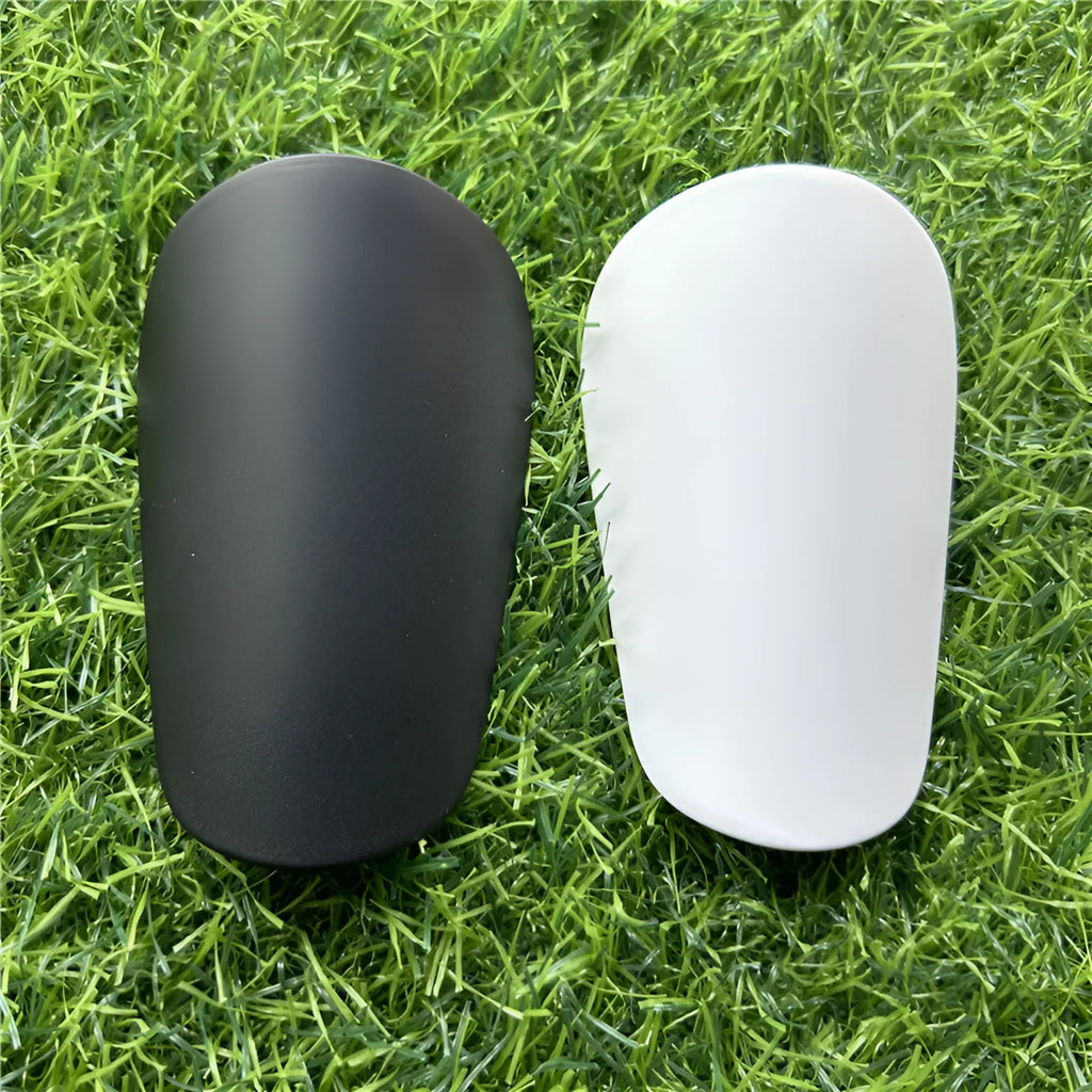 Extra small mini football shin guards in black and white, measuring 8x5cm