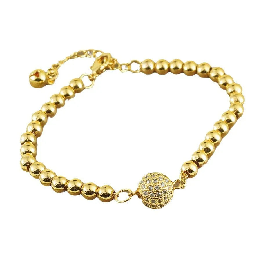 Arabic-style women's copper bracelet with a heart-shaped zircon ornament on a model's wrist.