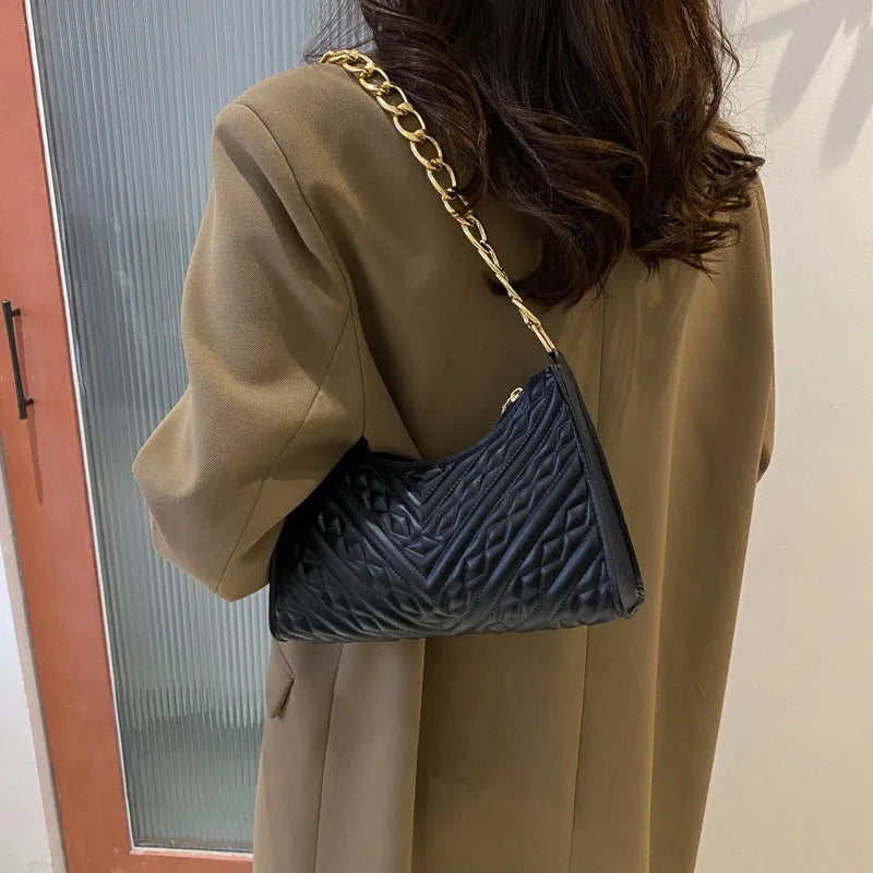 Black PU leather pleated square baguette bag with chain shoulder strap and top handle.