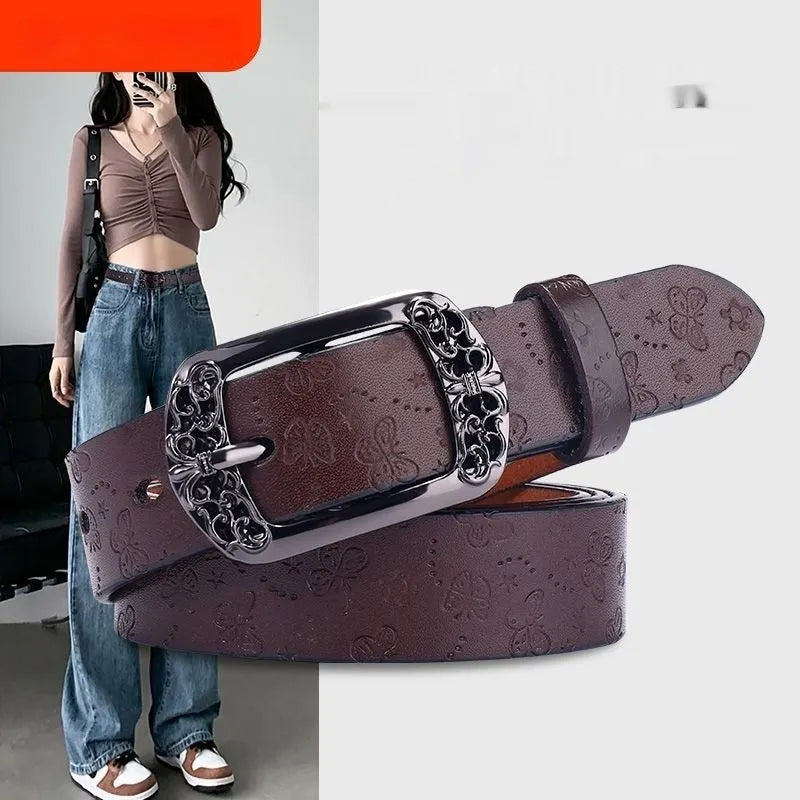 Thin black PU leather women's decorative belt with an alloy buckle on a pair of jeans.