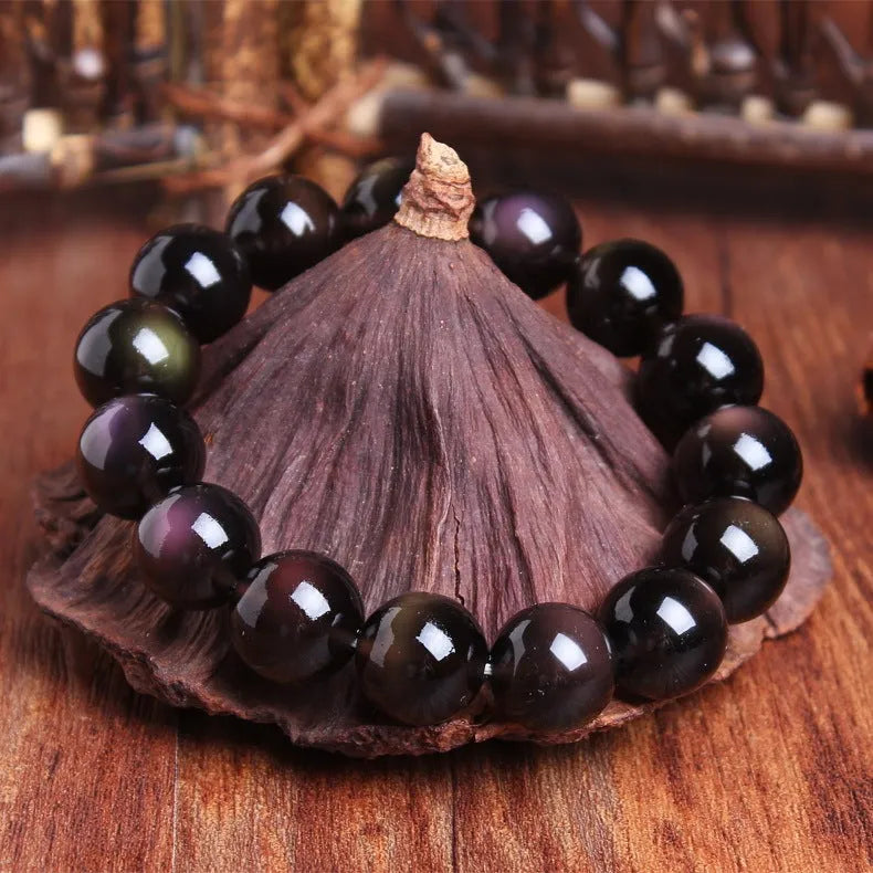 Polished crystal Pi Xiu bracelet with geometric beads on wrist, showing ice stone colour.