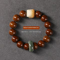Hand-woven bracelet with 13mm round beads showing lion design in ivory nut, bodhi or sandalwood style