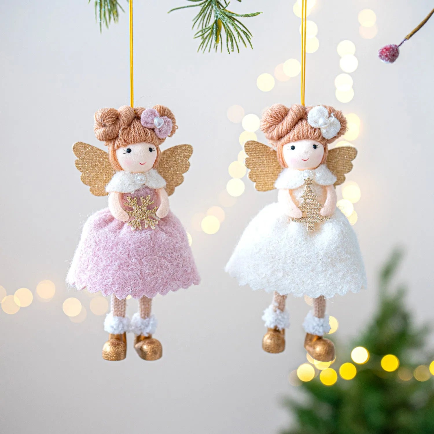 Pink and white cloth Christmas angel wings plush pendant decoration on a neutral background.