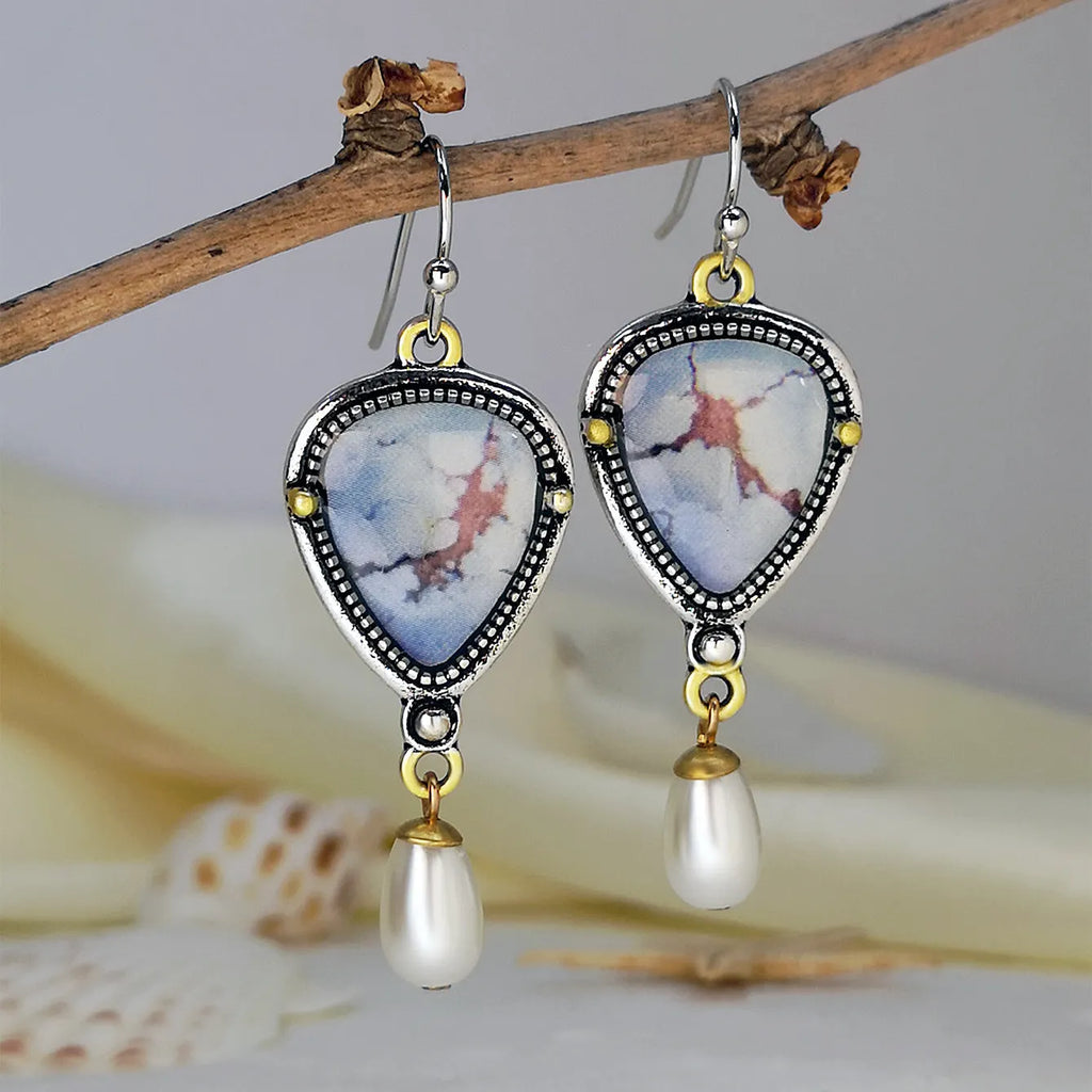 Retro blue bohemian drop earrings with synthetic opal and white pearl on metal.