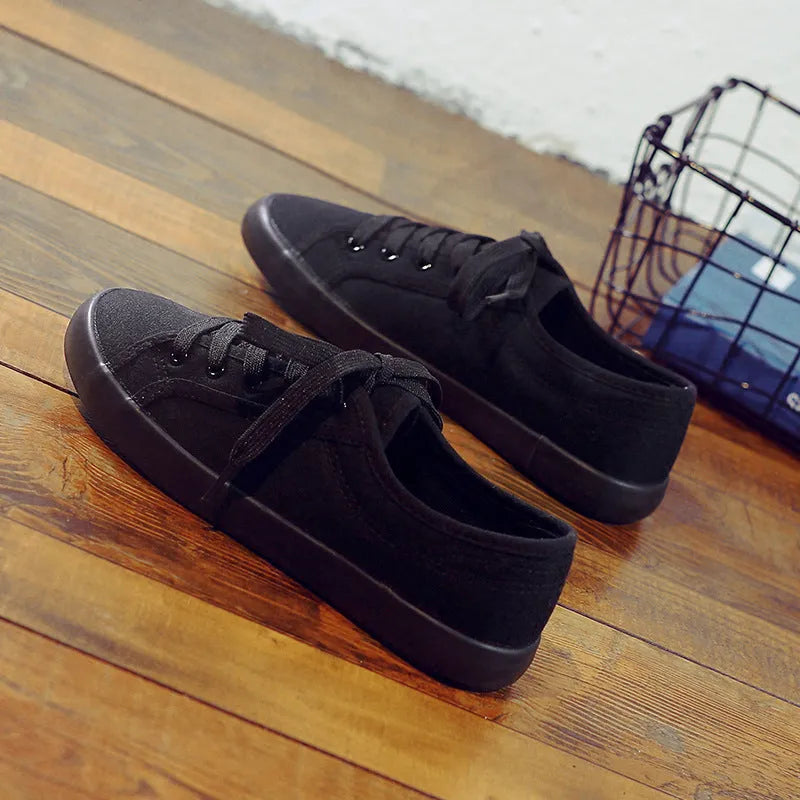 All black women's flat canvas lace-up shoes with a rubber sole