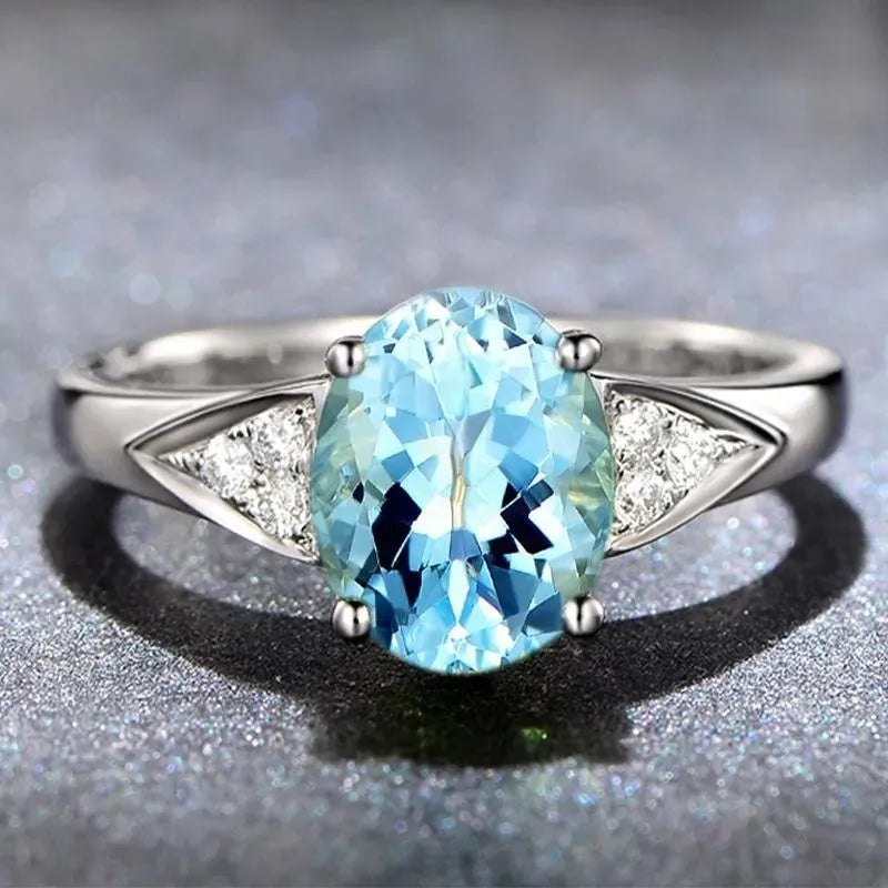 Women's court ring with heart-shaped natural zircon in red, blue, green, or light blue on a metal band.