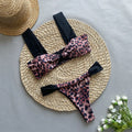 Women's black and leopard print tube top bikini set laid flat, showing the sleeveless top and briefs.