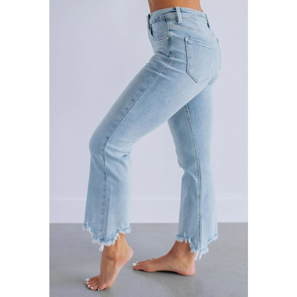 Women's solid colour denim pants with hand-worn distressing in dark blue and light blue.