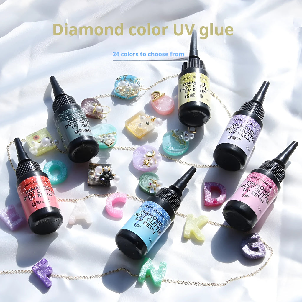 UV epoxy diamond 24 colour set with gold, silver, blue, pink, and green sequins on a white surface