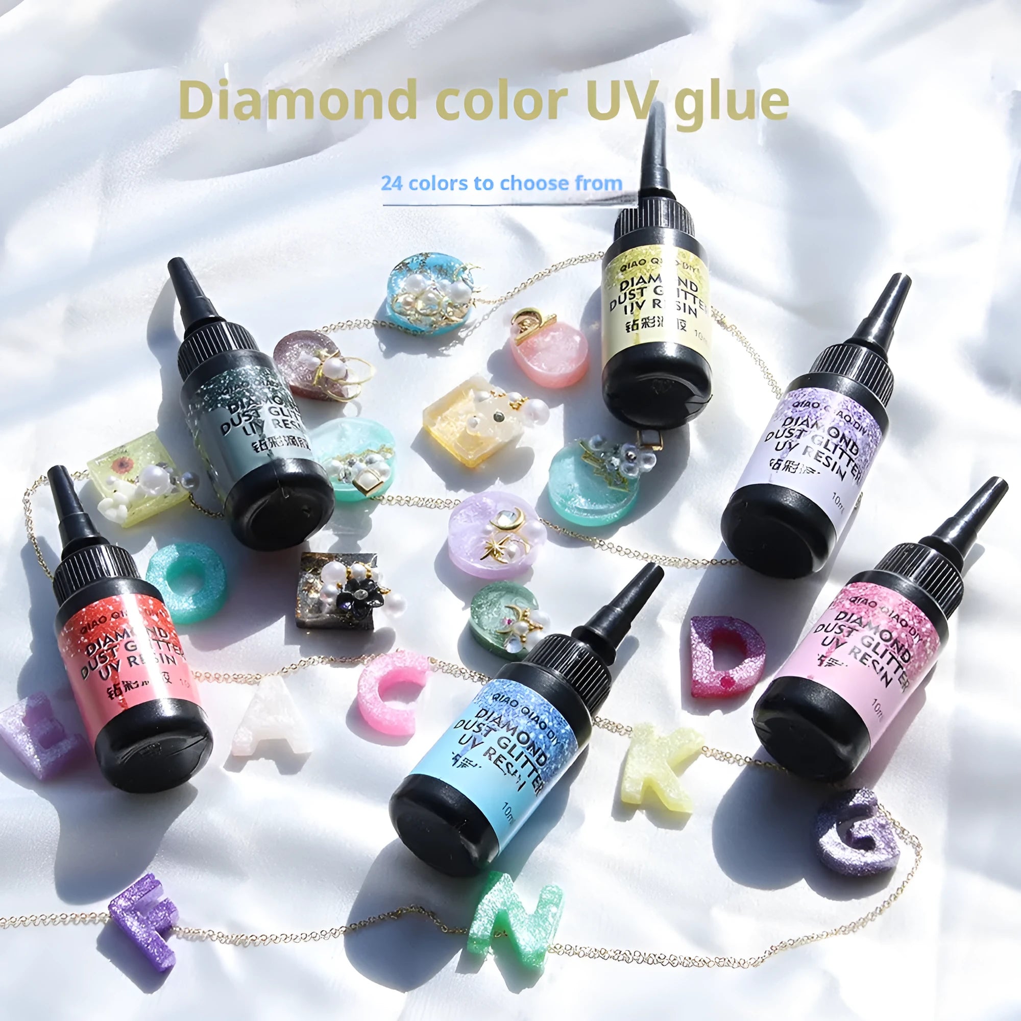 UV epoxy diamond 24 colour set with gold, silver, blue, pink, and green sequins on a white surface